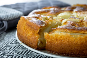 close up of a golden pear clafoutis coming out of the oven